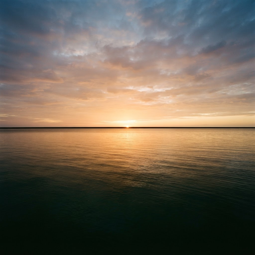 First light breaking over a still horizon