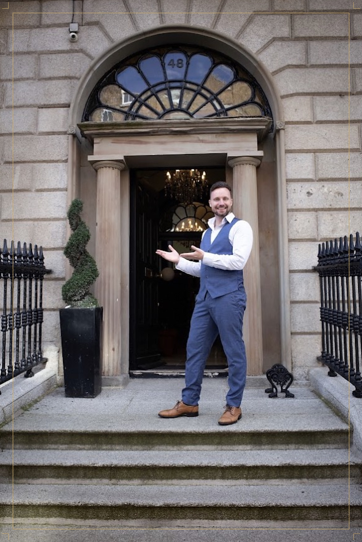 Marian Barnow welcoming visitors on the granite steps of number 48, beneath the Georgian fanlight